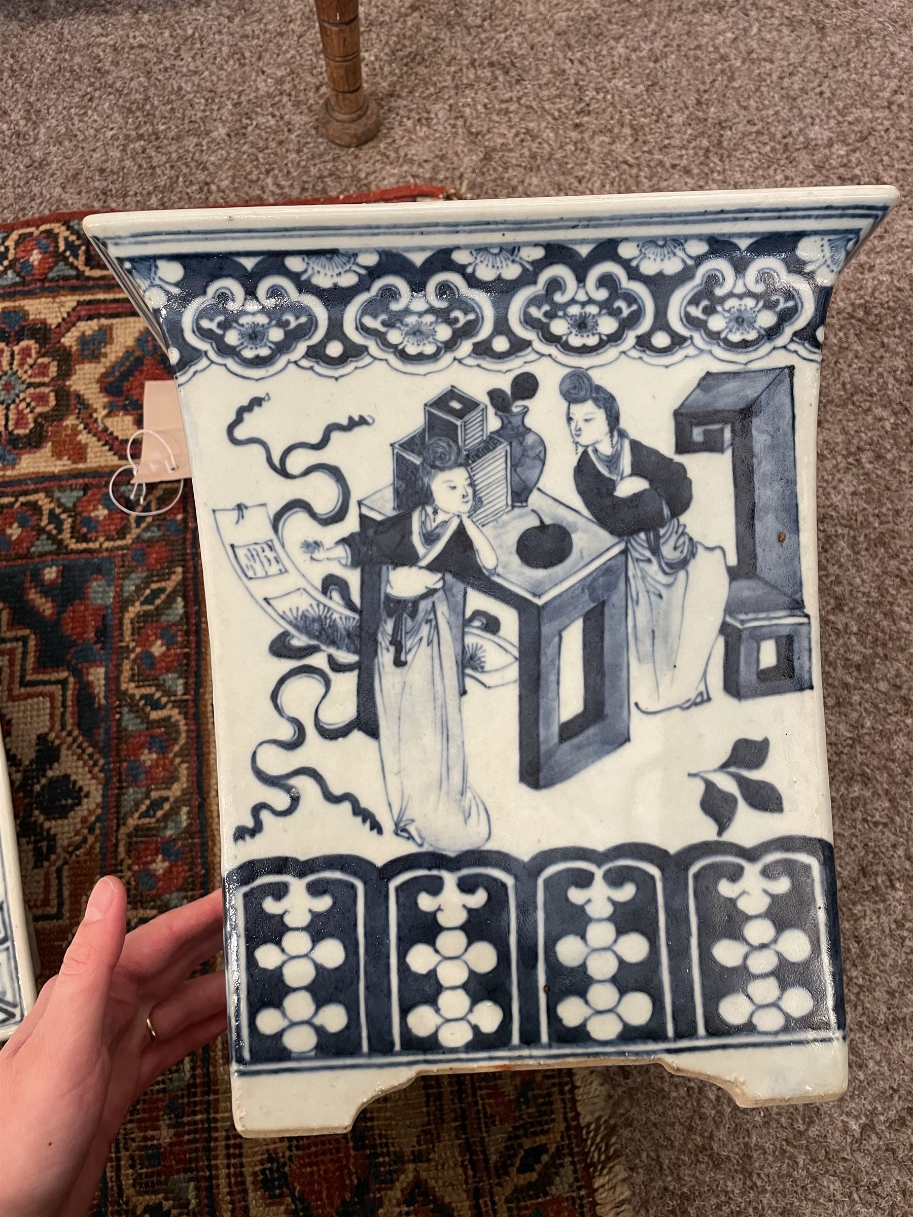 19th century Chinese blue and white planter and stand, each of square slightly tapering and flared form, the planter decorated with figures and precious objects between stylised foliate borders, the stand decorated with landscapes beneath a lipped rim with cell band, planter H28cm D25.5cm, stand H7cm D26cm