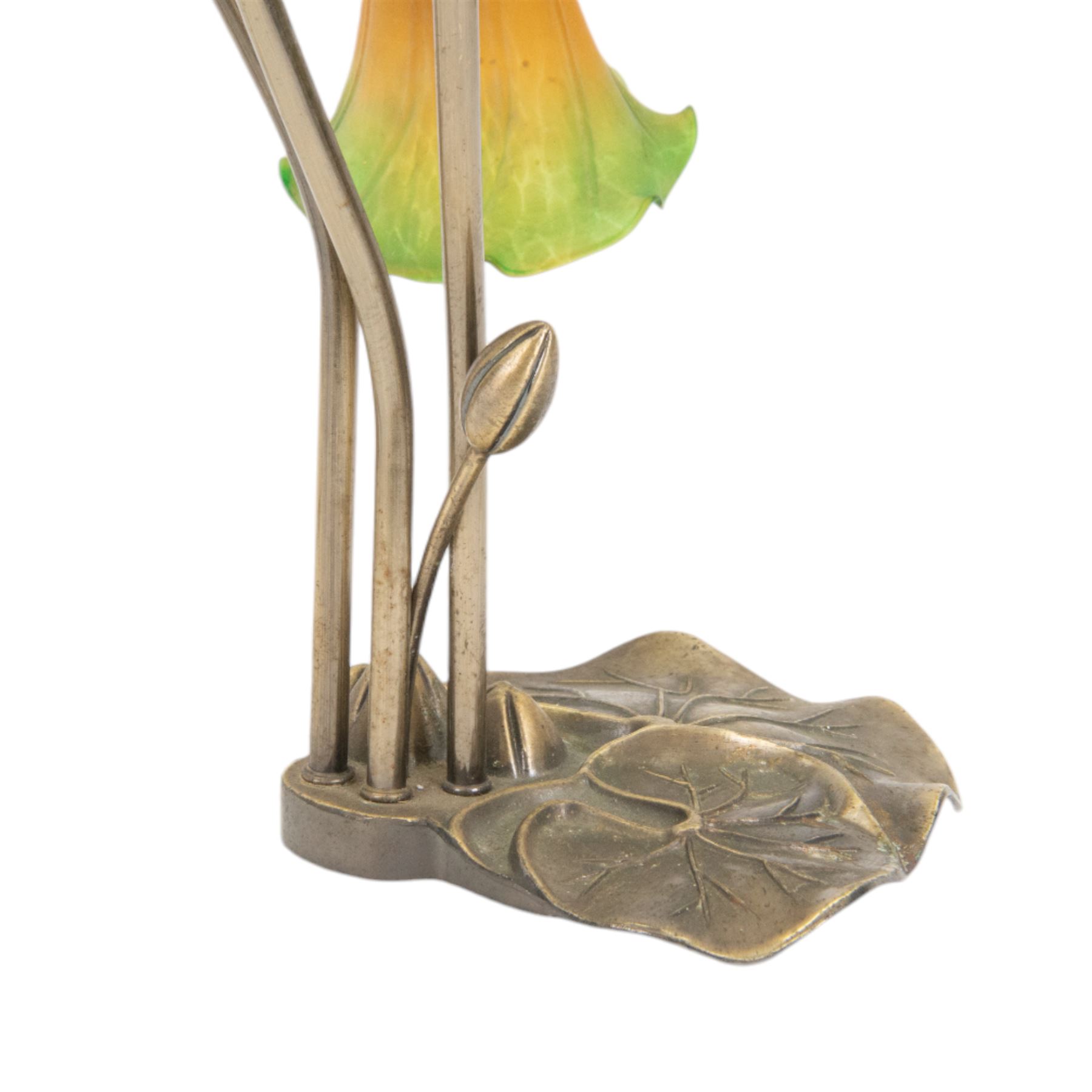 Art Nouveau Tiffany style table lamp, the bronzed base modelled as lily pads leading to tendrils and three branches supporting green and yellow glass lily flower shades, H42cm