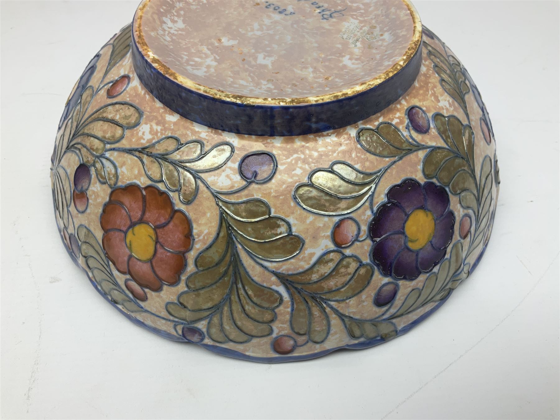 Charlotte Rhead for Crown Ducal ceramics, comprising coffin shaped vase depicting a woman in 1920s dress, a vase with handle, decorated with autumn leaves and a bowl, decorated with flowers and berries, with printed and signed marks beneath, coffin vase H24cm
