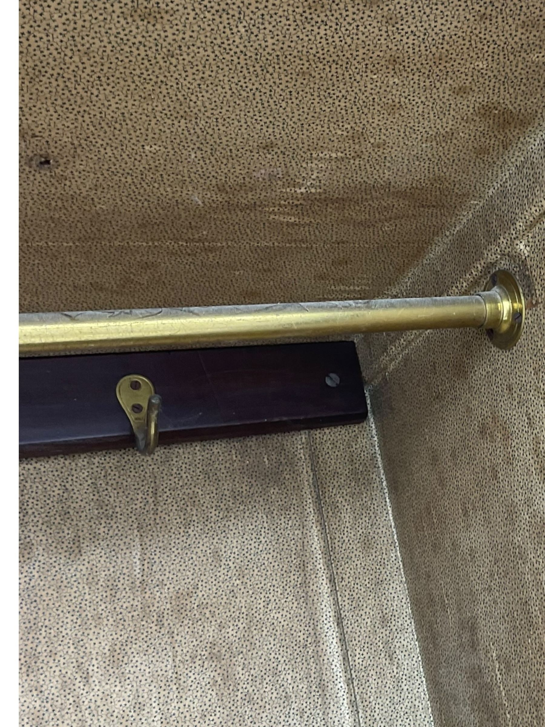 Late Victorian walnut triple combination wardrobe, projecting moulded and dentil cornice, central shaped bevelled mirror glazed door, cartouche and curled leaf carved panels over figured walnut veneered panels, fitted with drawer to base, on bracket feet