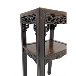 Early 20th century Chinese hardwood and marble jardinière or urn stand, rectangular form with red variegated marble inset over under tier, mounted with pierced and carved frieze rails and brackets, scroll carved support terminals