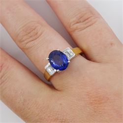 18ct gold tanzanite and diamond ring, single stone oval cut tanzanite of approx 1.75 carat, with two baguette cut diamonds set either side, stamped 750