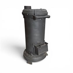 Late Victorian cast iron stove of small proportions, decorated with scrolls and central ro...