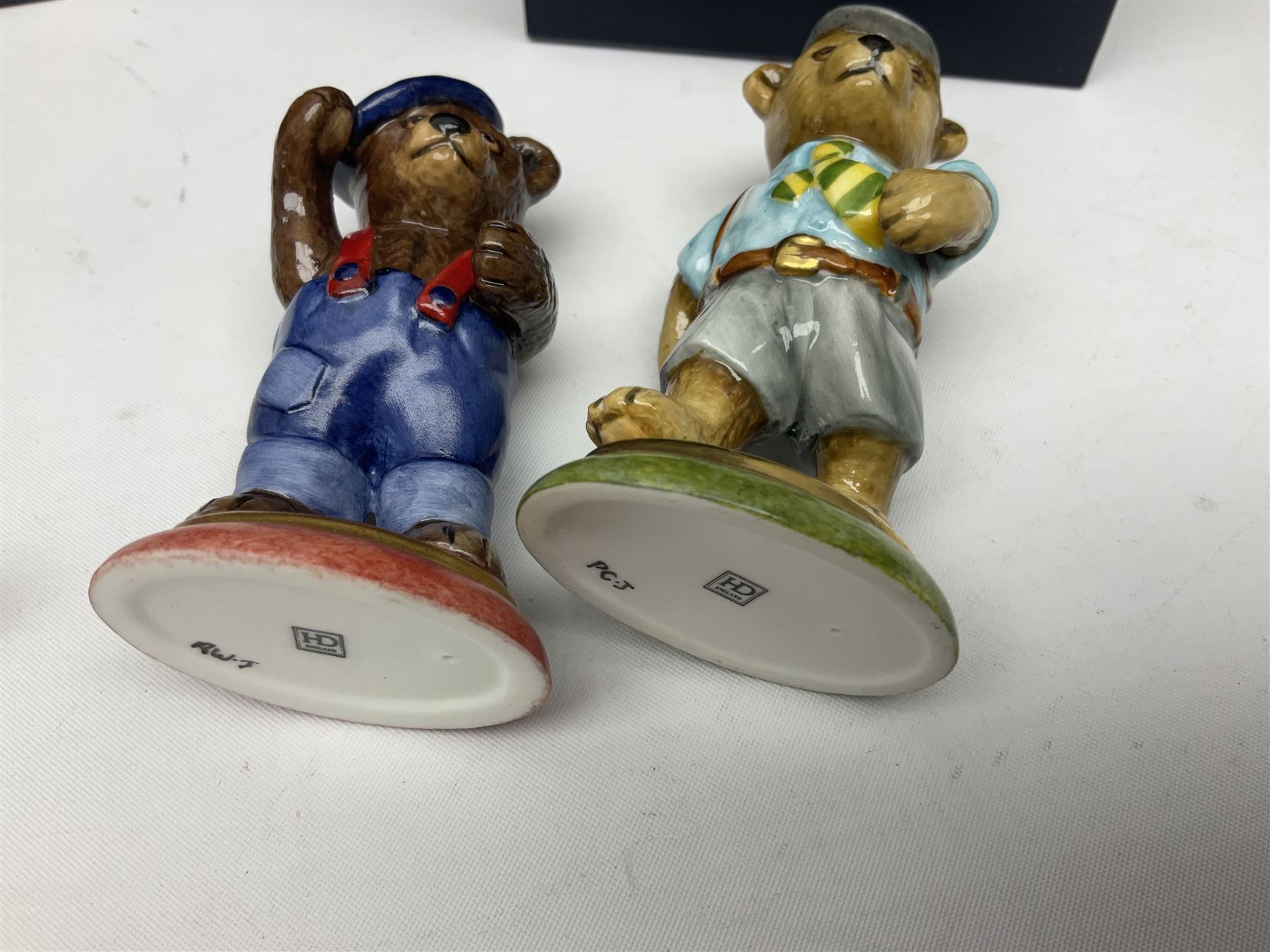 Eight Halcyon Days Teddy Bear of the Year figures, from 1993 to 2000, including one example modelled as a bear in Greek dress carrying a torch, one example modelled as a schoolboy and one example in a blue dress, all boxed 