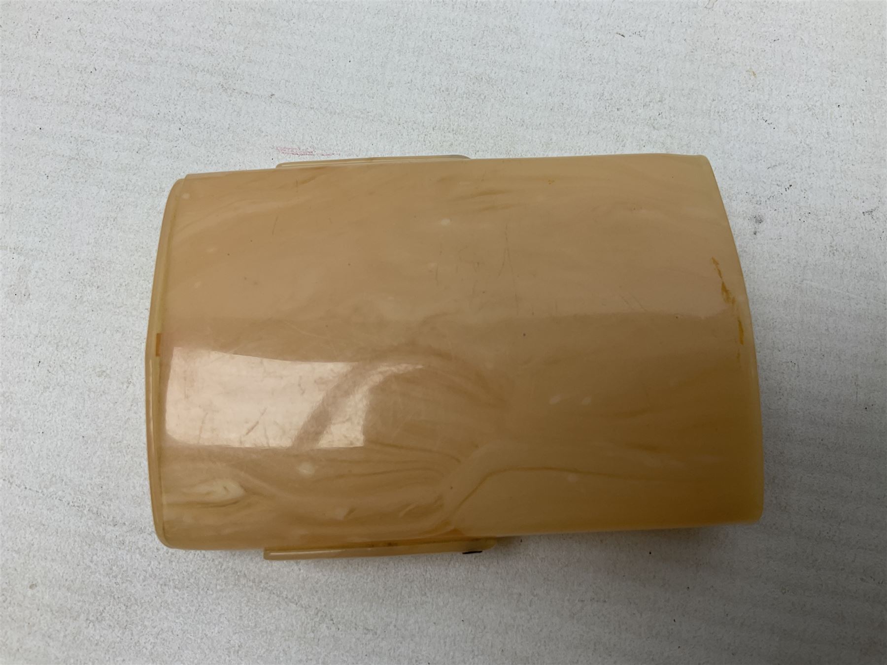 Mother of pearl and abalone inlaid card case, with central diamond shaped panel engraved with foliate decoration, together with a simulated mother of pearl card case of book form with green sun rays to cover, and simulated wood effect cigarette case with hinged lid with diamante style banding, largest L10cm