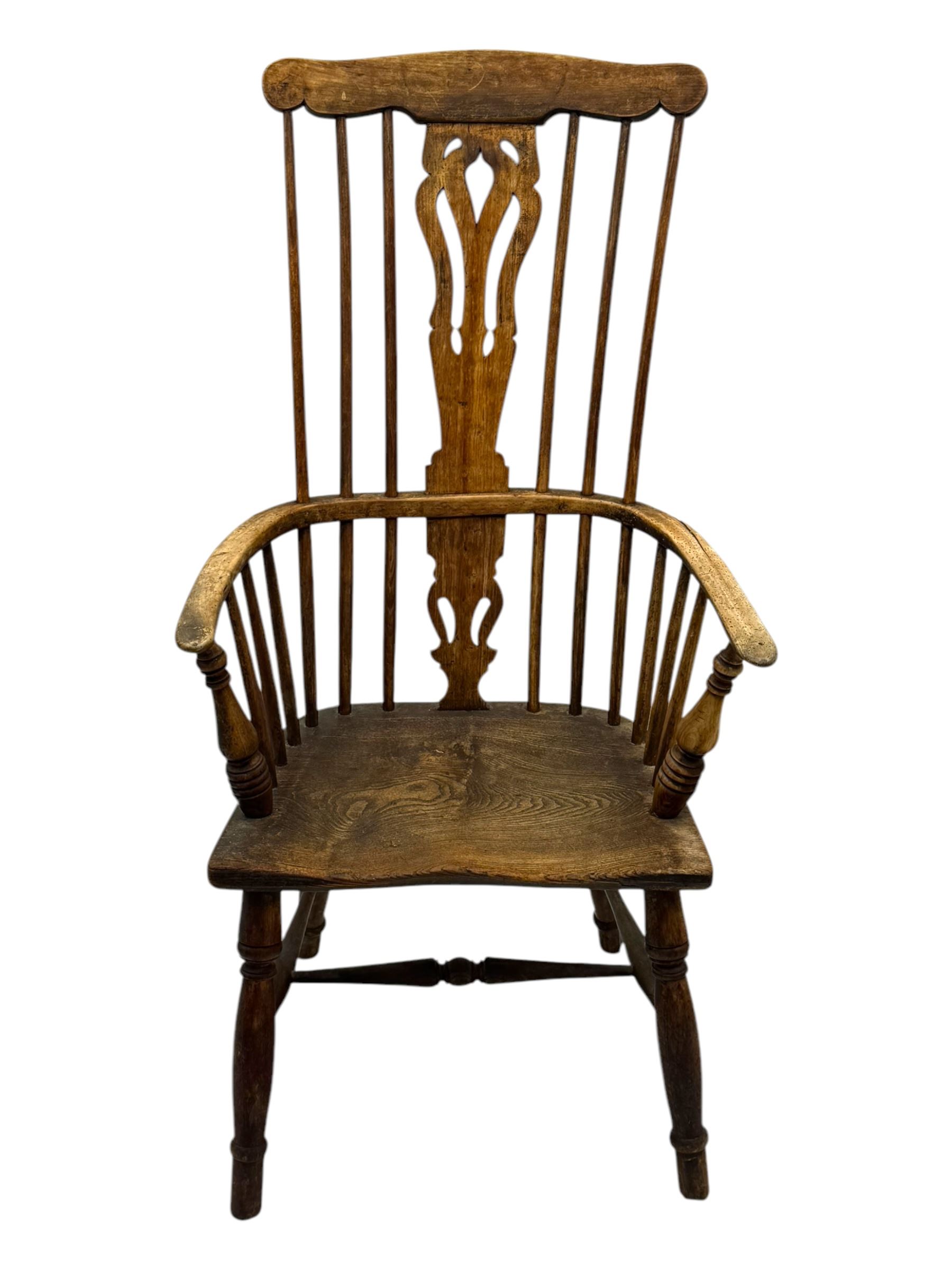 19th century provincial elm and beech Windsor armchair, shaped cresting rail over stick back with pierced and shaped splat, the dished seat on turned supports united by turned stretchers 