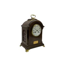 A small early 20th century mahogany bracket clock retailed by Walker Hall Ltd c1920, with a French 8-day rack striking movement striking the hours and half hours on a coiled gong, with a convex enamel dial, Roman numerals and minute track, steel moon hands within a glazed cast brass bezel, case with side frets, raised on four bracket feet with a brass carrying handle and contemporary presentation plaque. With pendulum.

 



