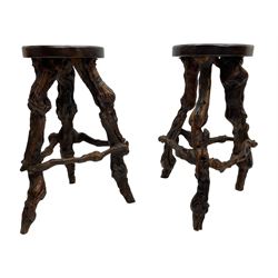 Mid-20th century French grapevine and walnut bow-front wine tasting bar, the curved counter top supported by sculptural grapevine roots, fitted with single shelf and raised on rustic vine feet (W100cm H101cm); with a pair of matching bar stools, the circular top raised on three gnarled root supports united by stretchers (W50cm H70cm)
