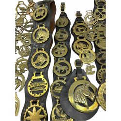 Large collection of horse brasses, including four with ceramic bosses depicting heavy horses.  