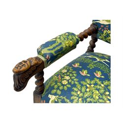 19th century Carolean design oak armchair, upholstered in a vibrant fabric depicting woodland and wildlife scenes, carved lion mask arm terminals, raised on barley twist supports united by H-stretcher