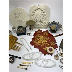 A group of assorted collectables, to include silver mounted box with unassociated silver napkin ring, silver sugar tongs, small silver mounted glass pot, silver pendant, pounce pot, pair of glass inkwells, Victorian mesh purse, Victorian papier lacquer fan, two Neoclassical type plaster plaques, novelty brass tilt top table, cheroot holder, bone handled seal, bone counter in the form of a fish, etc. 