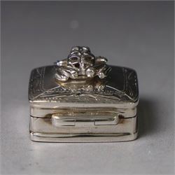 Modern silver pill box, of square form, the hinged cover surmounted with figure of a frog within a engraved scroll edge, hallmarked hallmarked Martin Gerald & Sid Adler, London 2000, W3cm