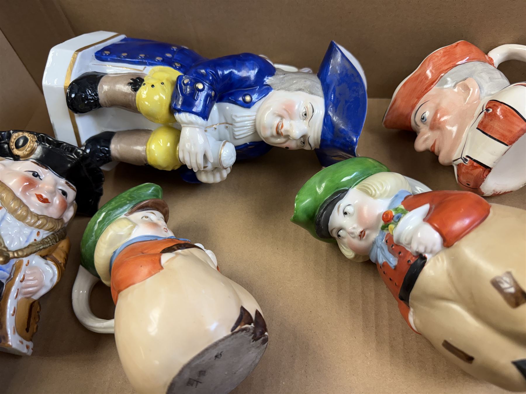 19th century ceramic toby jug with gold anchor mark to base, together with a collection of other toby jugs, tallest H21cm