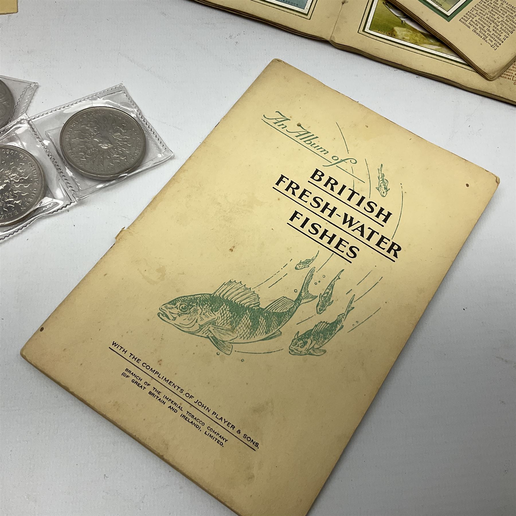 Quantity of Kensitas silk cigarette cards depicting world flags, together with albums of fish cigarette cards and quantity of crowns to include boxed examples