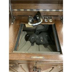 Early 20th century ‘HMV' 202 cabinet gramophone, oak cased, moulded top with foliate carved moulding hinges to reveal gramophone, two doors enclosing horn, on turned supports joined by moulded stretcher rails