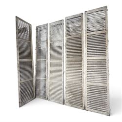 Five 19th century full height French Chateau louvre doors, pitch pine painted in cream finish, two having iron rod hinges, dimensions approx.