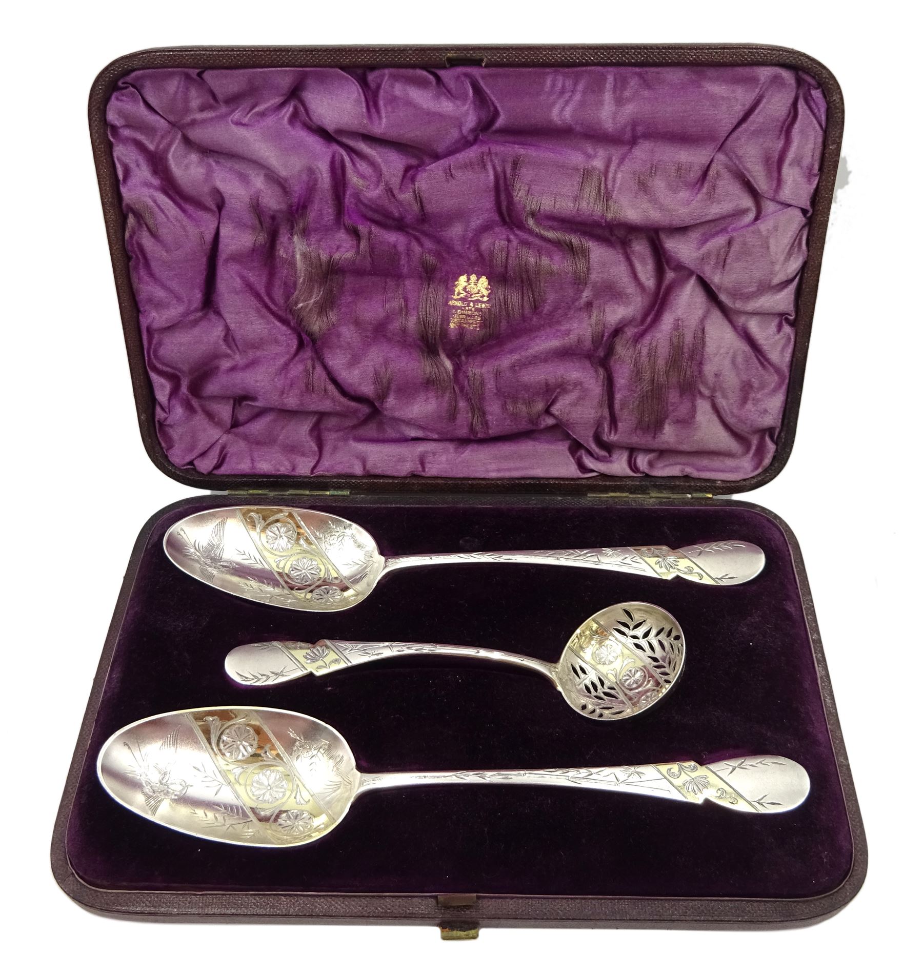 Pair of George IV silver strawberry spoons by Adam Elder, Edinburgh 1829, with later bright cut decoration and a matched Victorian sifter Edinburgh 1864, approx 5.3oz, retailed by Arnold & Lewis, Manchester cased