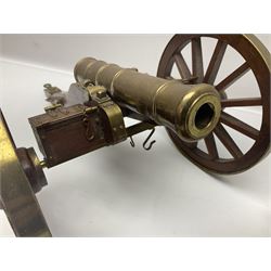 Large model brass cannon, upon wooden base, together with two similar smaller cannons, largest L48cm