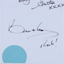 Birthday card and postcard, each signed by Brian May and Anita Dobson, with a personalised Anita Dobson compliment slip dated 2008, in glass frame