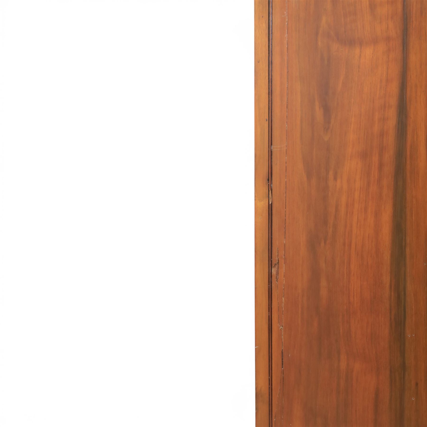Edwardian walnut double wardrobe, featuring two mirrored doors with bevelled plates, carved frieze with fluted pilasters, above single base drawer