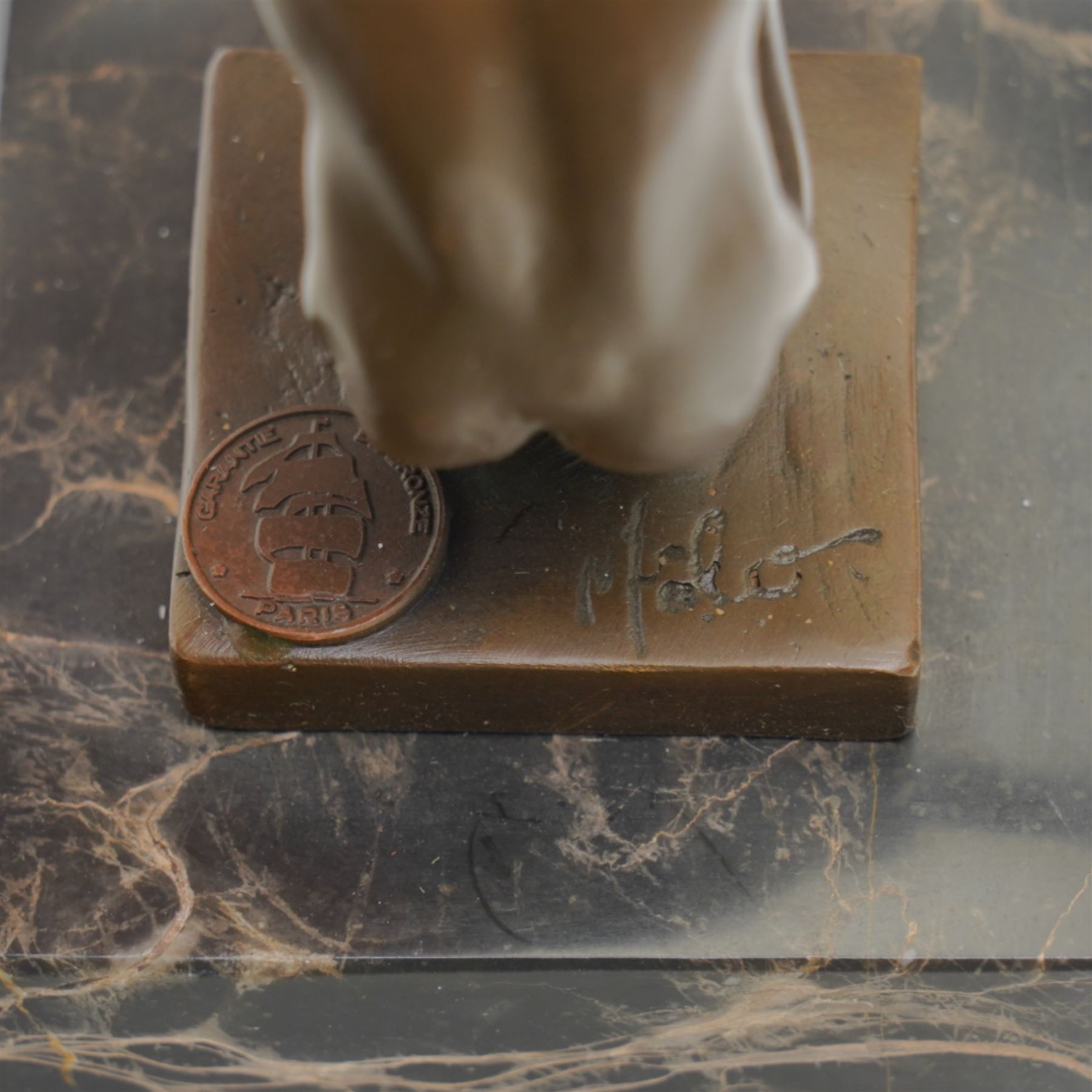 Bronze figure after Milo, a 'Power Of Silence', modelled as a male athlete crouched with arms outstretched upon a marble plinth, signed Milo, H15cm