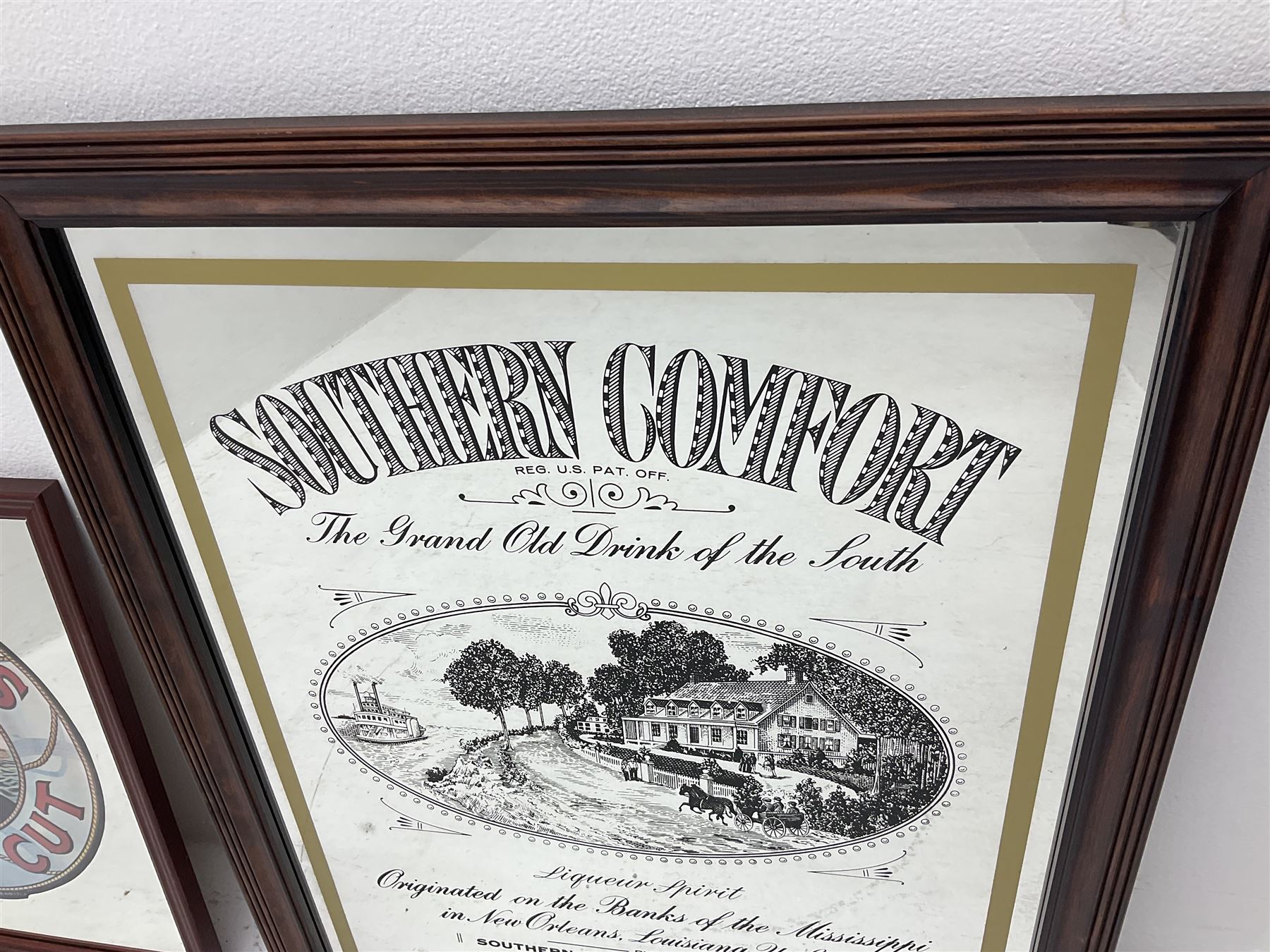 Four advertising mirrors, comprising of Southern Comfort, All Ranks smoke Marcella Cigars, Coca-Cola and Player's Navy Cut, largest example H70cm, L60.5cm