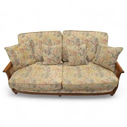 Ercol – bergère four piece suite, including armchair, two seat sofa, three seat sofa and footstool, all with removable floral upholstered cushions, the frames with side caning and rounded arm supports in stained beech

Three seat (H 87cm, D 89cm, W 196cm)
Two seat (H 87cm, D 89cm, W 137cm)
Armchair (H 87cm, D 89cm, W 87cm)
Footstool (H 28cm, D 55cm, W 55cm)