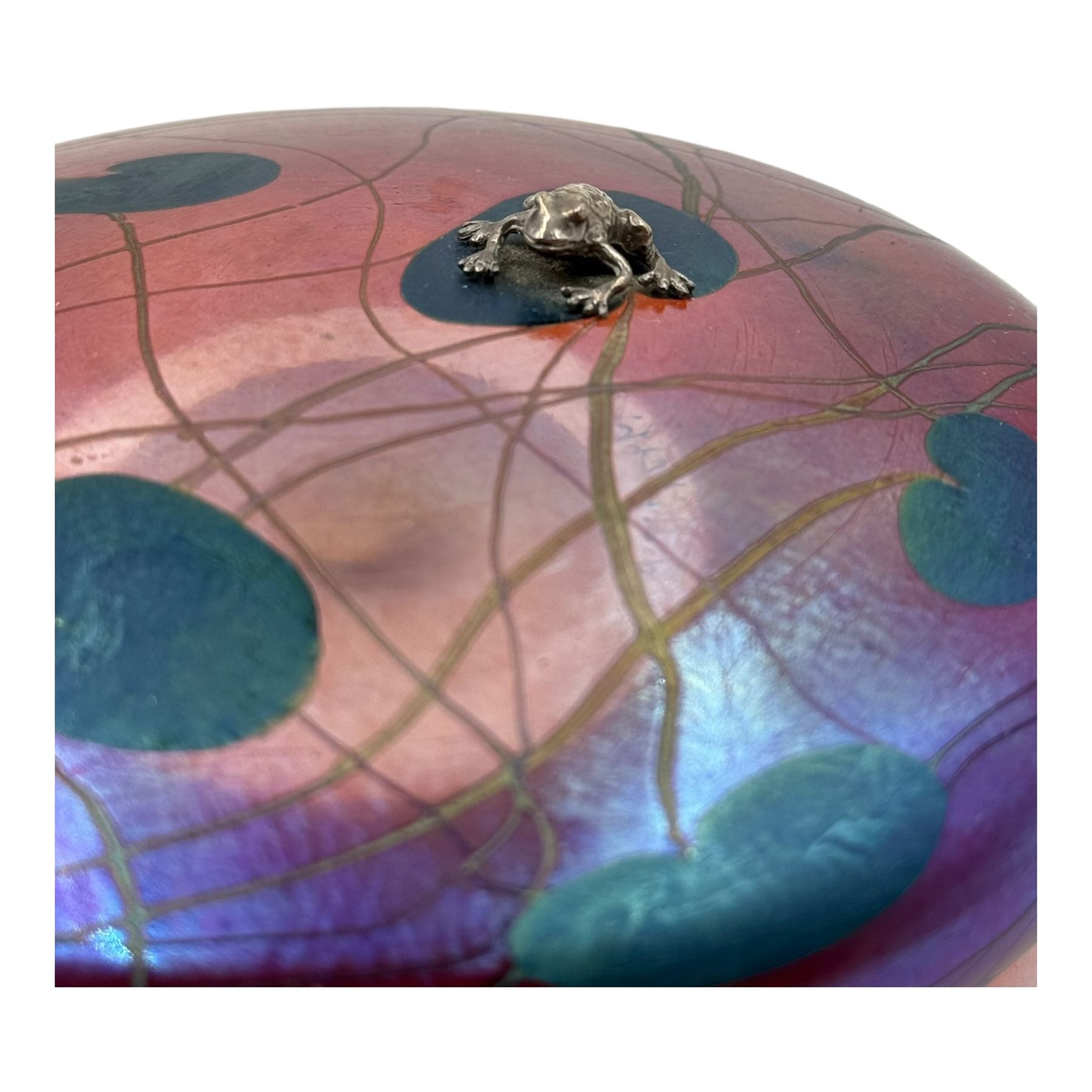 John Ditchfield for Glasform disc paperweight in iridescent cranberry with green lily pads and silver hallmarked frog to top, D14cm