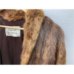 Brown mid length musquash fur coat by National Fur Company together with white rabbit cape