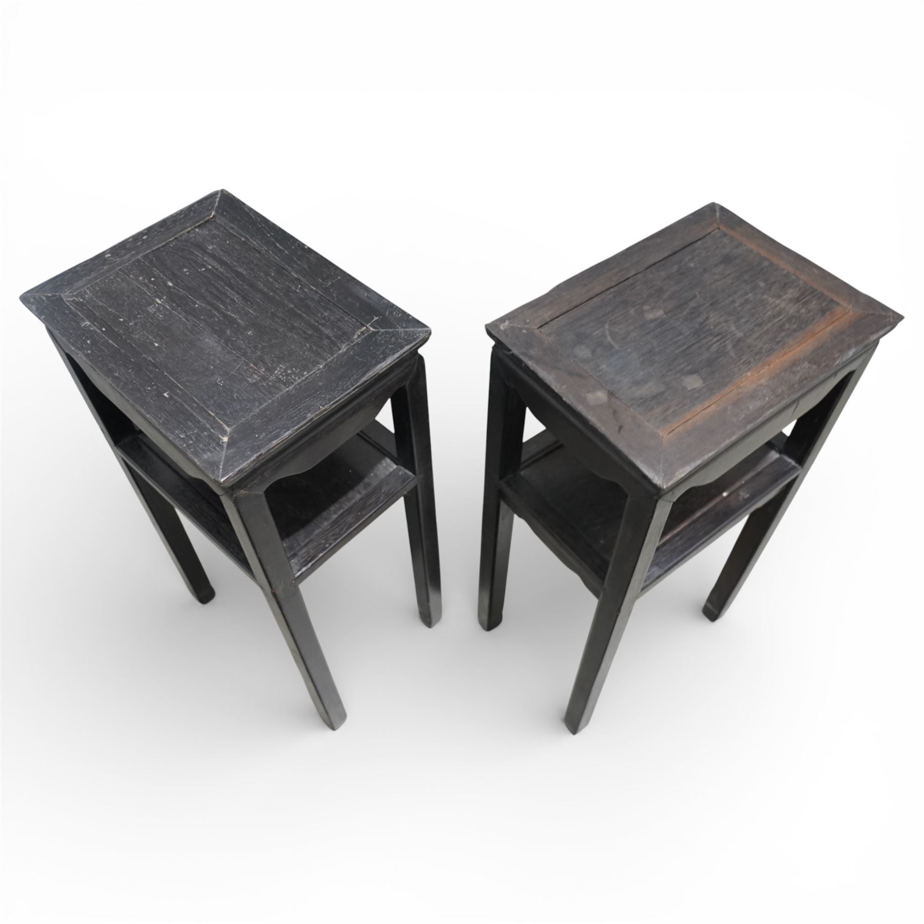 Near pair of 19th century Chinese hardwood stands, each with rectangular tops above plain friezes, open undershelves, square section legs joined by stretchers, black lacquered finish