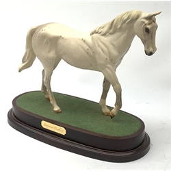 A Royal Doulton figurine modelled as the race horse Desert Orchid, upon a wooden oval base. 