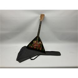 Russian balalaika with six-piece segmented back, the top painted with a scene of Russian onion capped buildings monogrammed K.B.H.1993; bears cyrillic label; L67.5cm; in carrying bag