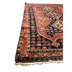 Persian indigo and crimson ground rug, the field with extending triple lozenge medallion, profusely decorated with bird motifs, triple band border with geometric design