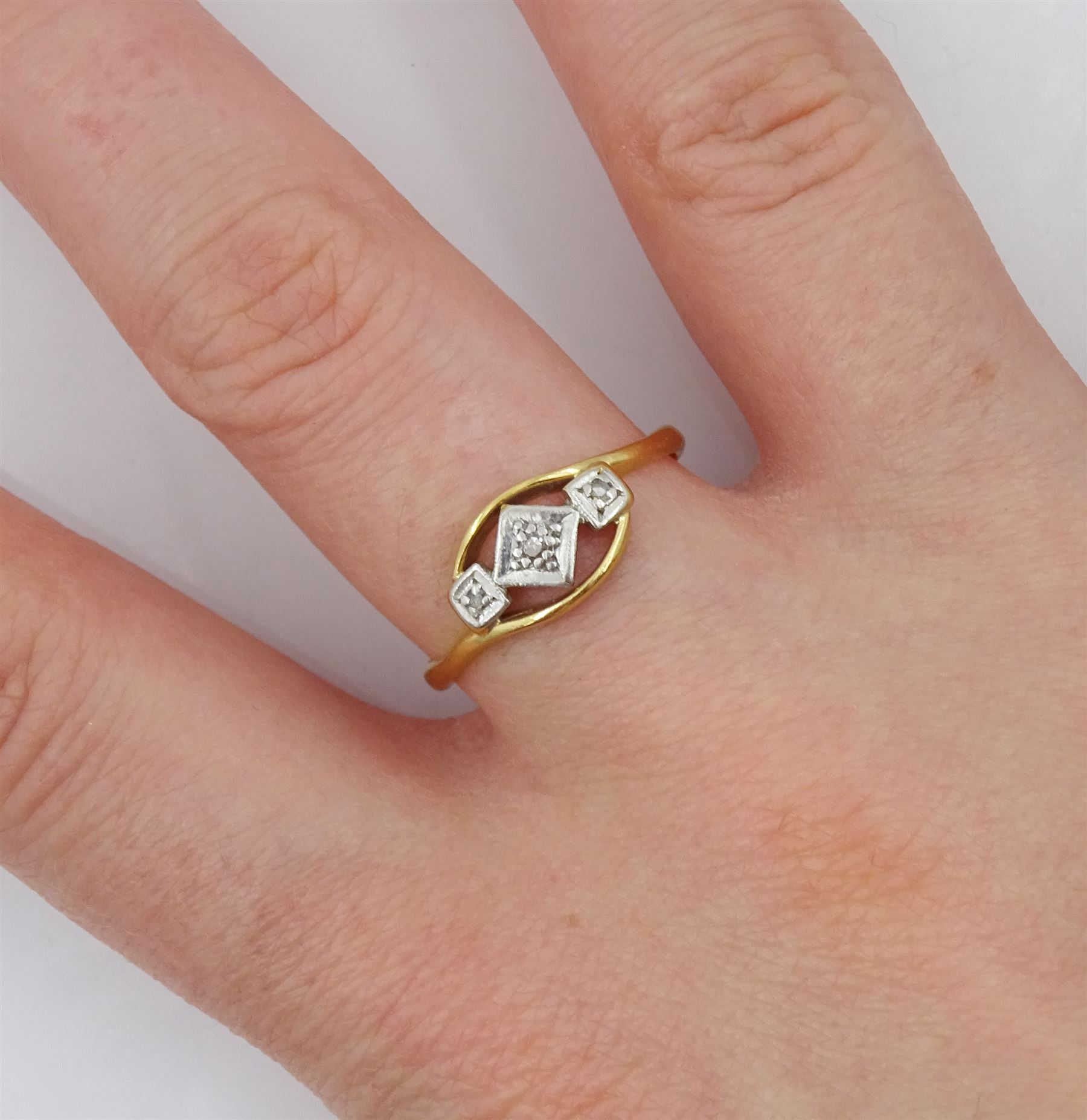 Early 20th century gold three stone diamond chip ring probably by
