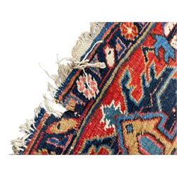 Persian blue ground carpet, the field divided up into panels by trailing bands with flower heads, each panel decorated with palmettes and stylised plant motifs, the border decorated with further palmettes, within floral pattern guard stripes 