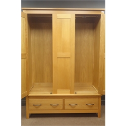  Triple oak wardrobe, three panelled doors enclosing fitted interior above two drawers, stile supports, W138cm, H192cm, D57cm  
