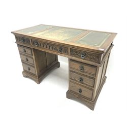 20th century medium oak twin pedestal desk, three piece inset leather writing surface, eight graduating drawers, ogee bracket supports