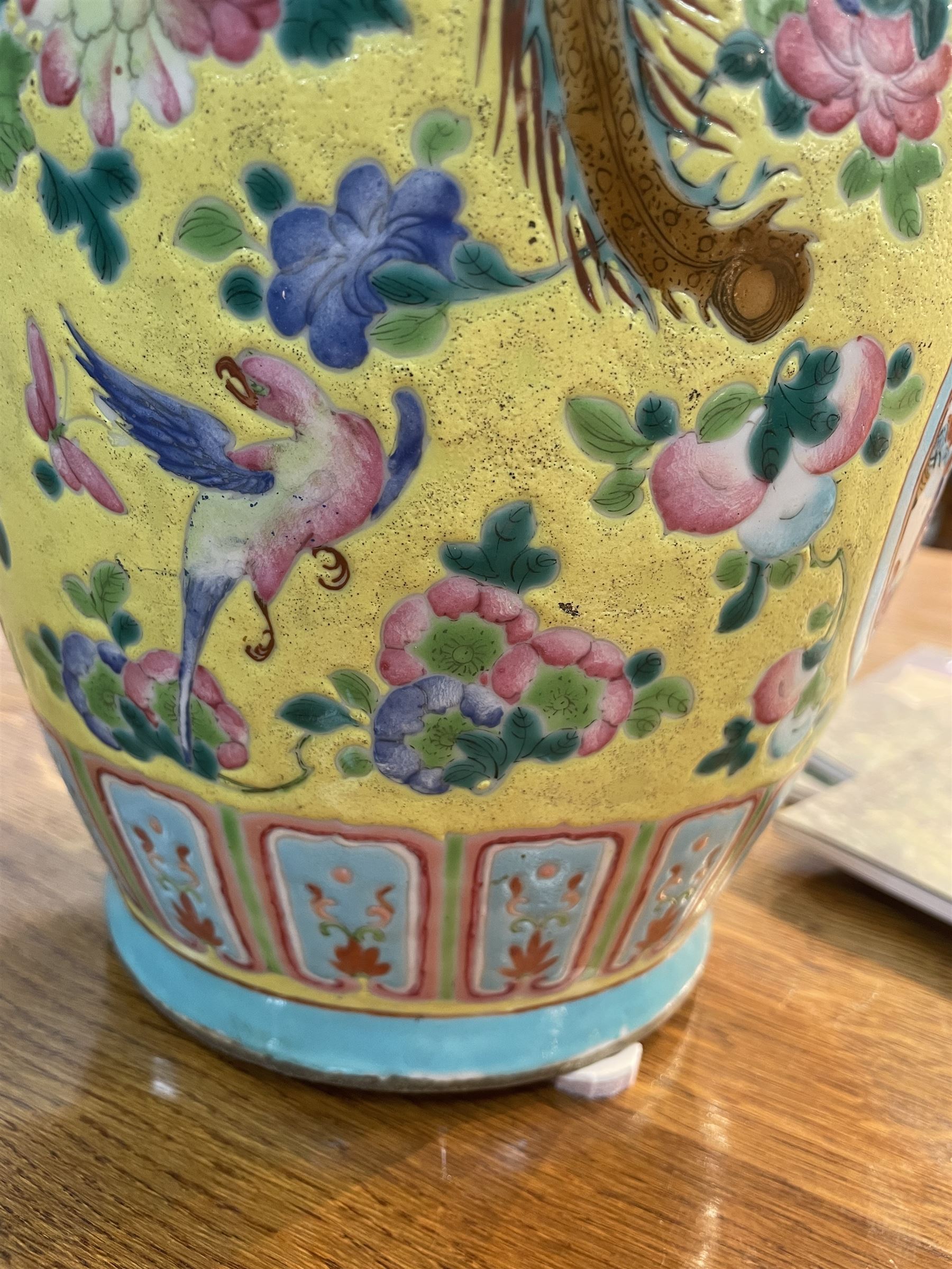 19th century Chinese famille rose yellow ground porcelain vase, of baluster form with twin applied mask ring handles, the body decorated with two shaped reserves mounted with dragon heads, depicting warriors at battle and at court, the neck with two smaller conforming figural reserves, upon a yellow ground decorated with exotic birds amidst scrolling blossom, H45.cm