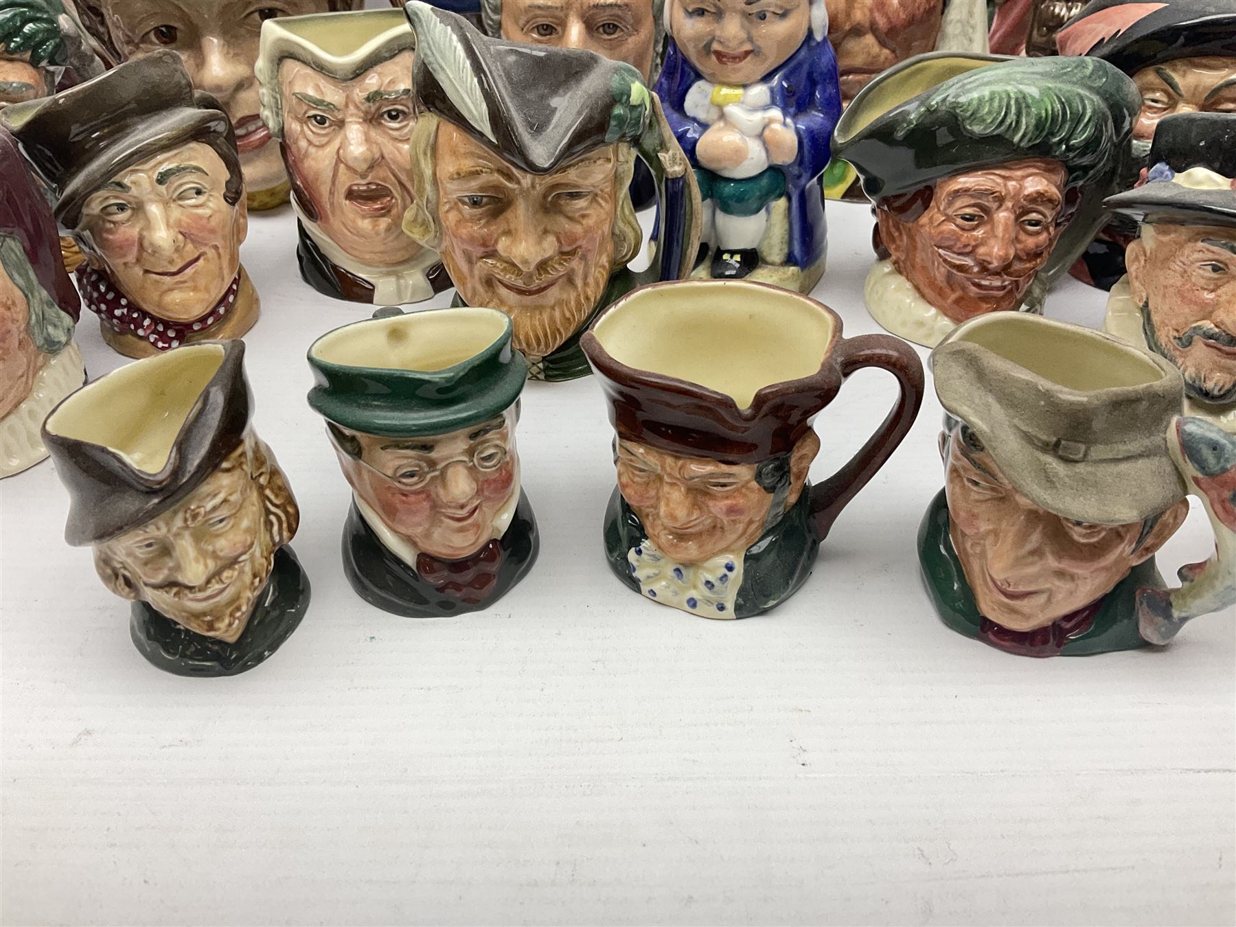 Collection of Royal Doulton and Beswick character jugs of various sizes, including North American Indian D6611, The Falconer D6533,  Tony Weller 281, Sairey Gamp 371 etc