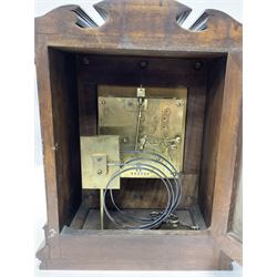 Lenzkirch - Late 19th century 8-day German mantle clock in a walnut veneered case with an architectural pediment, square brass dial, cast spandrels, matted dial centre, silvered chapter ring and fleur-di-Lis hands, with a twin train movement chiming the quarters on two coiled gongs and striking the hours on one. With Key and pendulum. Silver presentation plaque dated 1896.