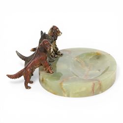 Art Deco ashtray, the oval green onyx tray with oval dished recess, the edge surmounted with three cold painted bronze dogs, comprising Irish Setter, Scottish Terrier and Springer Spaniel, each marked with incised H to base of foot, tray L17cm
