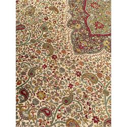 Persian design red ground rug, the central shaped medallion with floral palmette decoration, within an ivory field of scrolling Boteh motifs, guarded border with repeating stylised flower heads