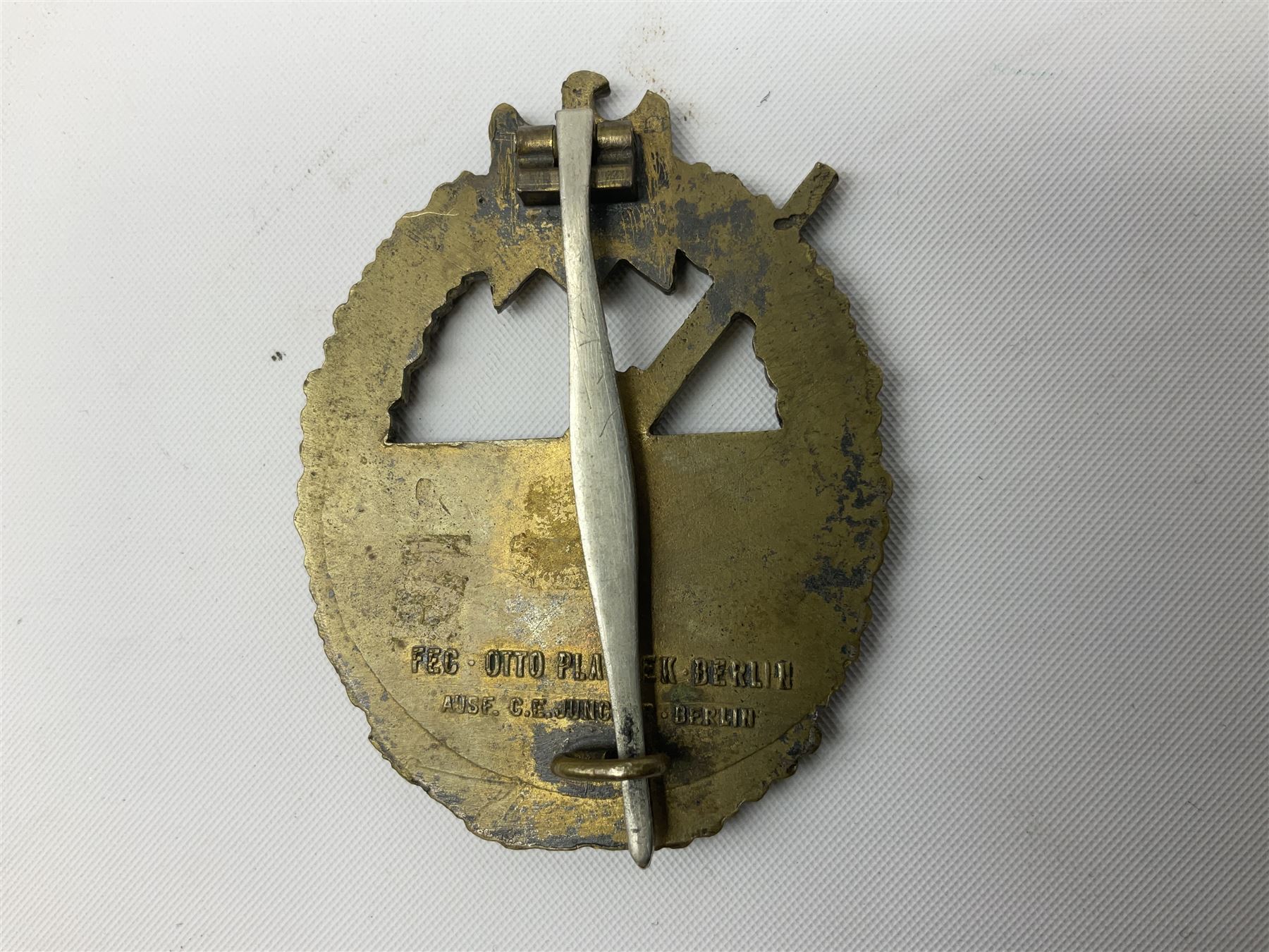 Three WW2 German badges comprising Blockade Runner War Badge and Coastal Artillery badge, both marked 'Fec Otto Placzec Berlin'; and Infantry Assault Badge; all with fixing pins (3)