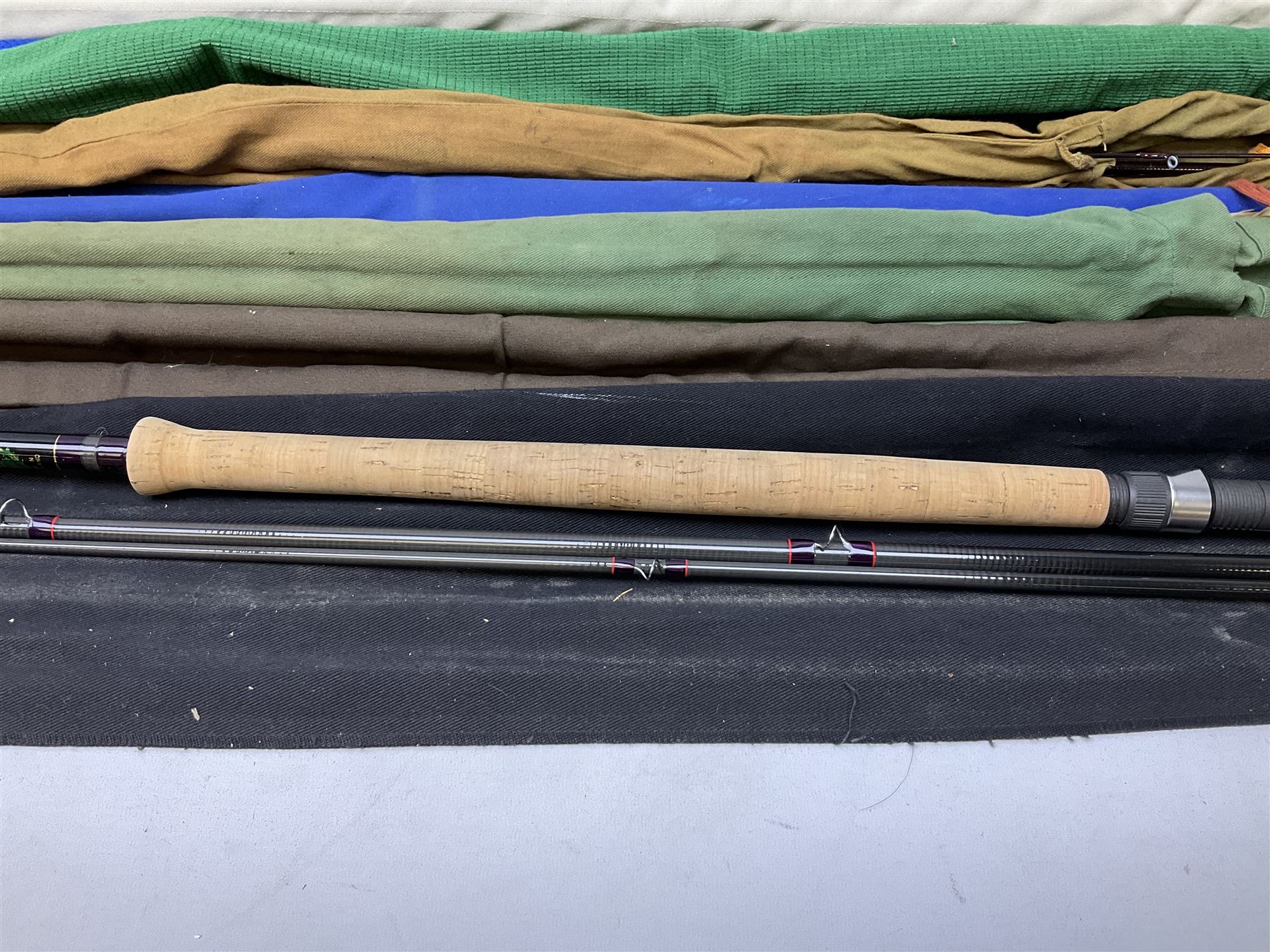 Twelve carbon fiber fishing rods in cloth covers, to include Normark fishing rod, Daiwa Carbon C98 etc (12)