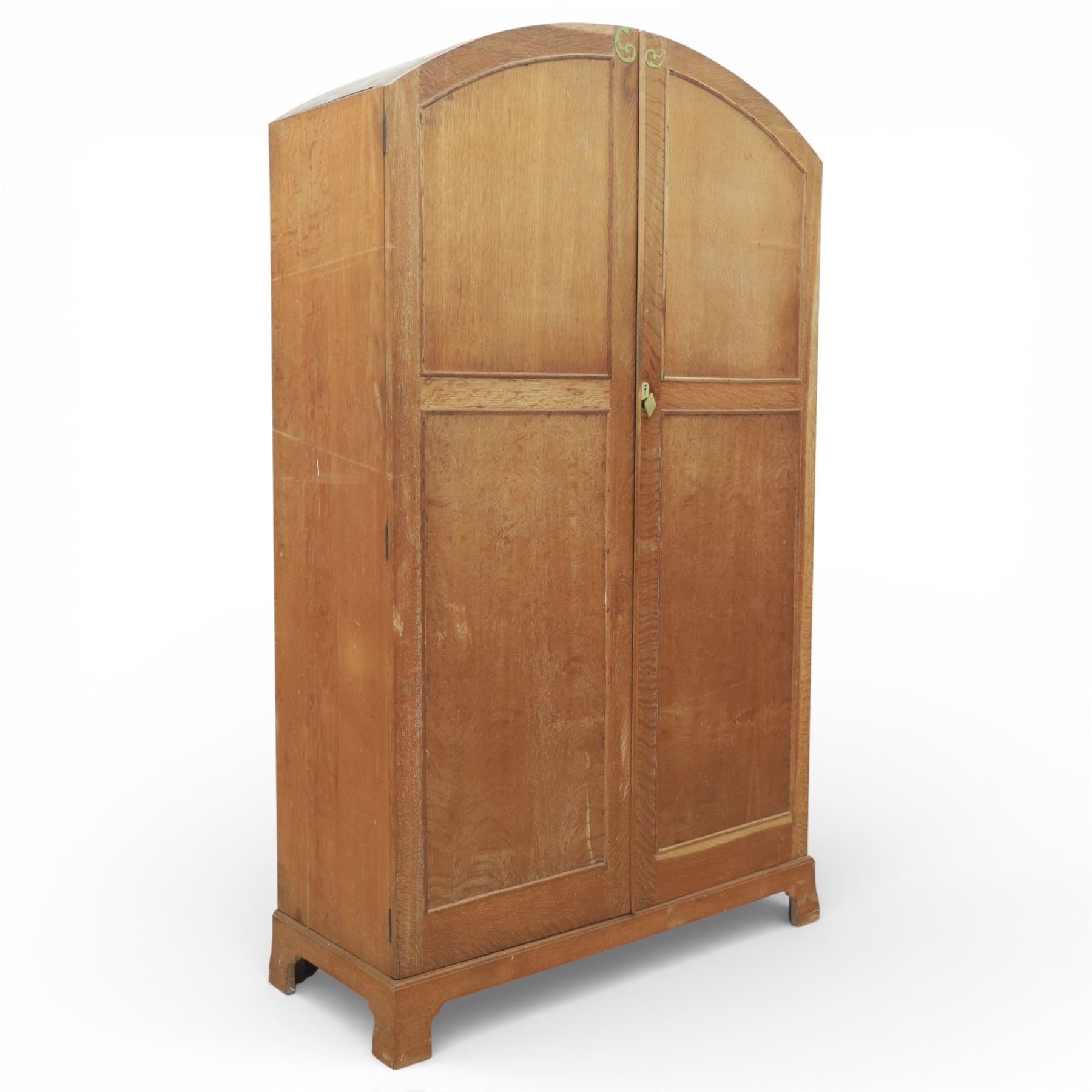 Early 20th century Art Deco bedroom suite, comprising double wardrobe, dressing table and chest of drawers, constructed in walnut with figured veneers and geometric banding, the wardrobe with arched top and panelled doors enclosing a fitted interior, the dressing table with rectangular top below a three panel mirror arrangement, fitted with two short over two long drawers, the chest with three short and three long drawers, each piece fitted with faceted handles and raised on shaped feet
Wardrobe (H 177cm, D 46cm, W 112cm)
Chest (H 85cm, D 48cm, W 92cm)
Dressing table (H 160cm, D 52cm, W 106cm)
