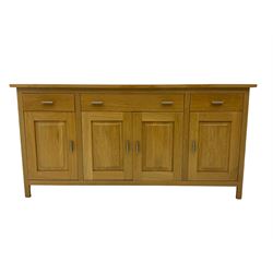 G-Plan - light oak sideboard, fitted with three drawers and four panelled cupboards