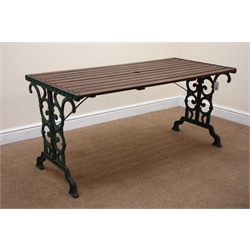  Cast iron and wood slatted rectangular garden table (W141cm, H66cm, D68cm) a matching two seat bench (W130cm) and pair armchairs (W63cm)  