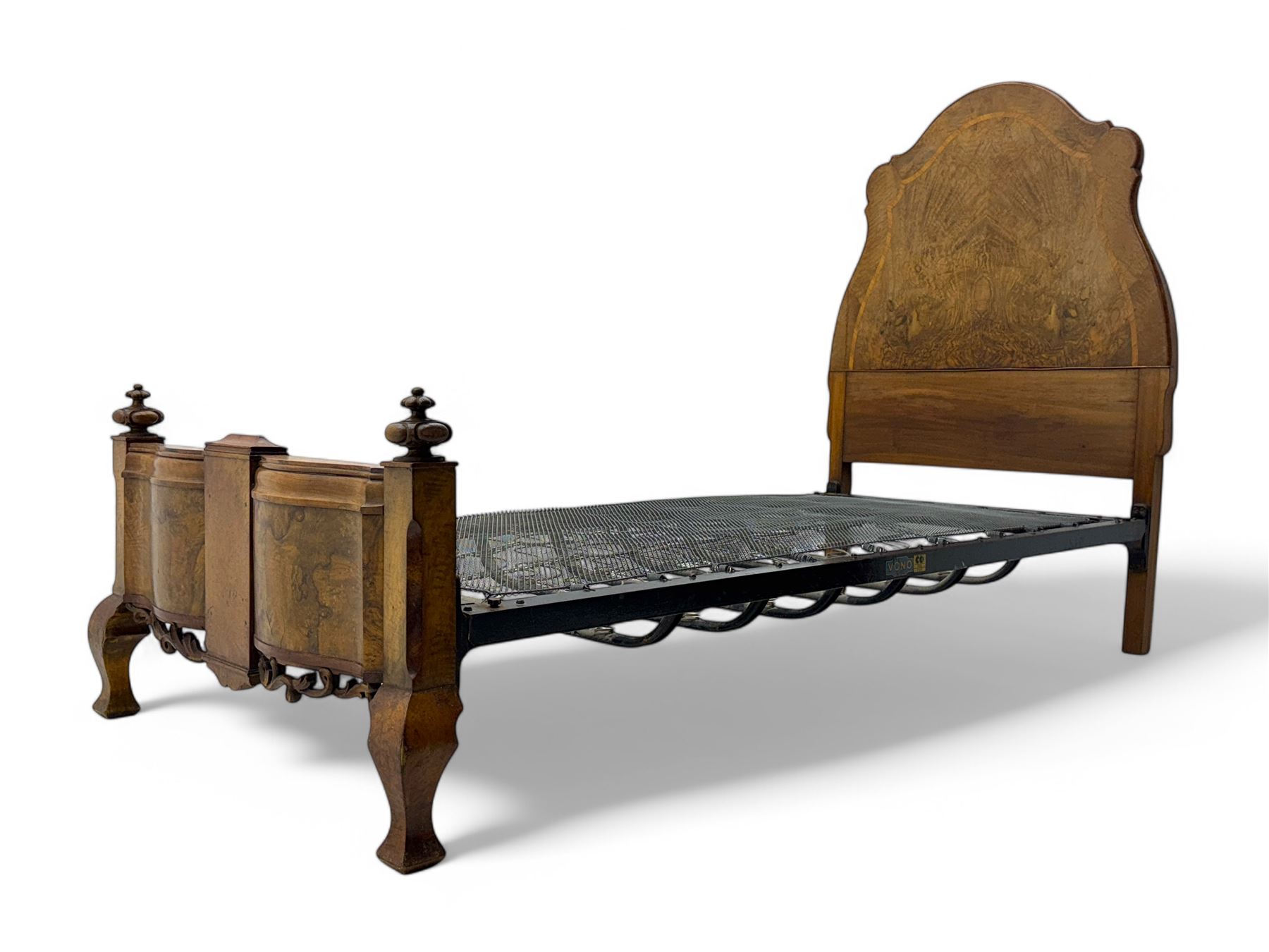 Mid-20th century walnut single bedstead, high shaped headboard, footboard with turned finials and scrollwork carvings, complete with 'Vono' iron frame, raised on cabriole supports