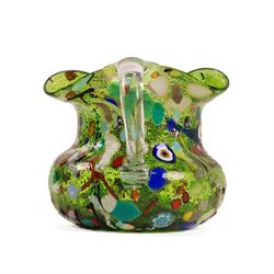 Two Murano Glass jugs by Zecchin, the fist decorated with millefiori design, upon a purple mottled ground, the other upon a green ground, H10cm