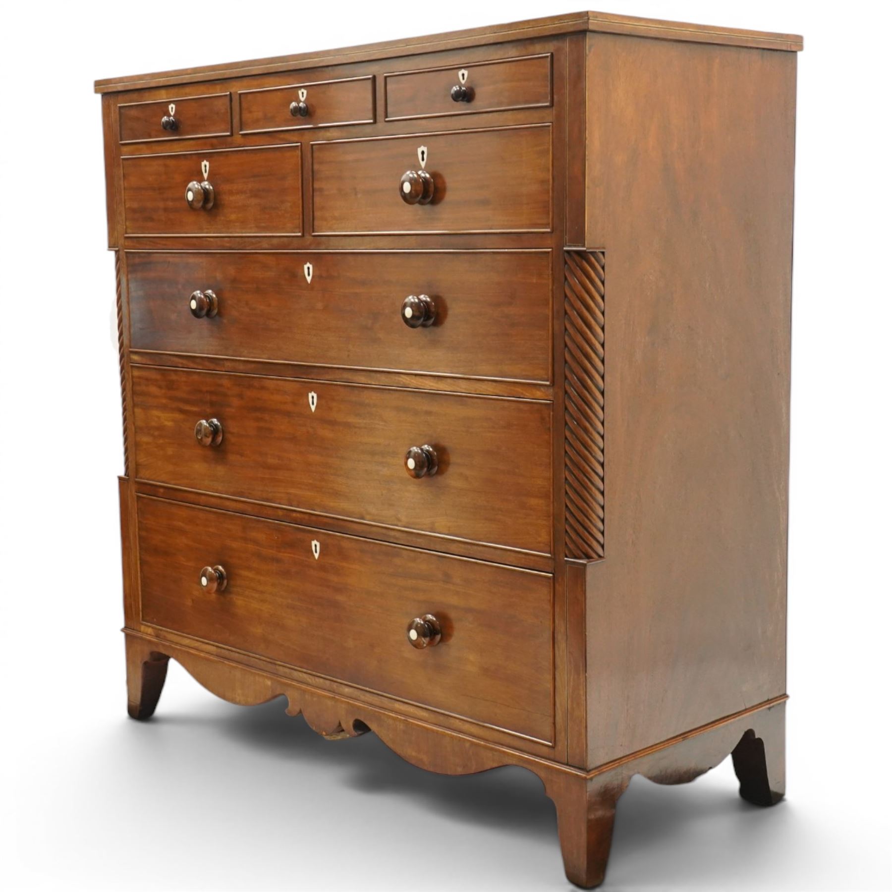 Large 19th century mahogany chest, with rectangular top with inlay flanked by spiral turned uprights, three short drawers above two short and three graduating long drawers, bone escutcheons and turned wooden handles, shaped apron raised on bracket feet 